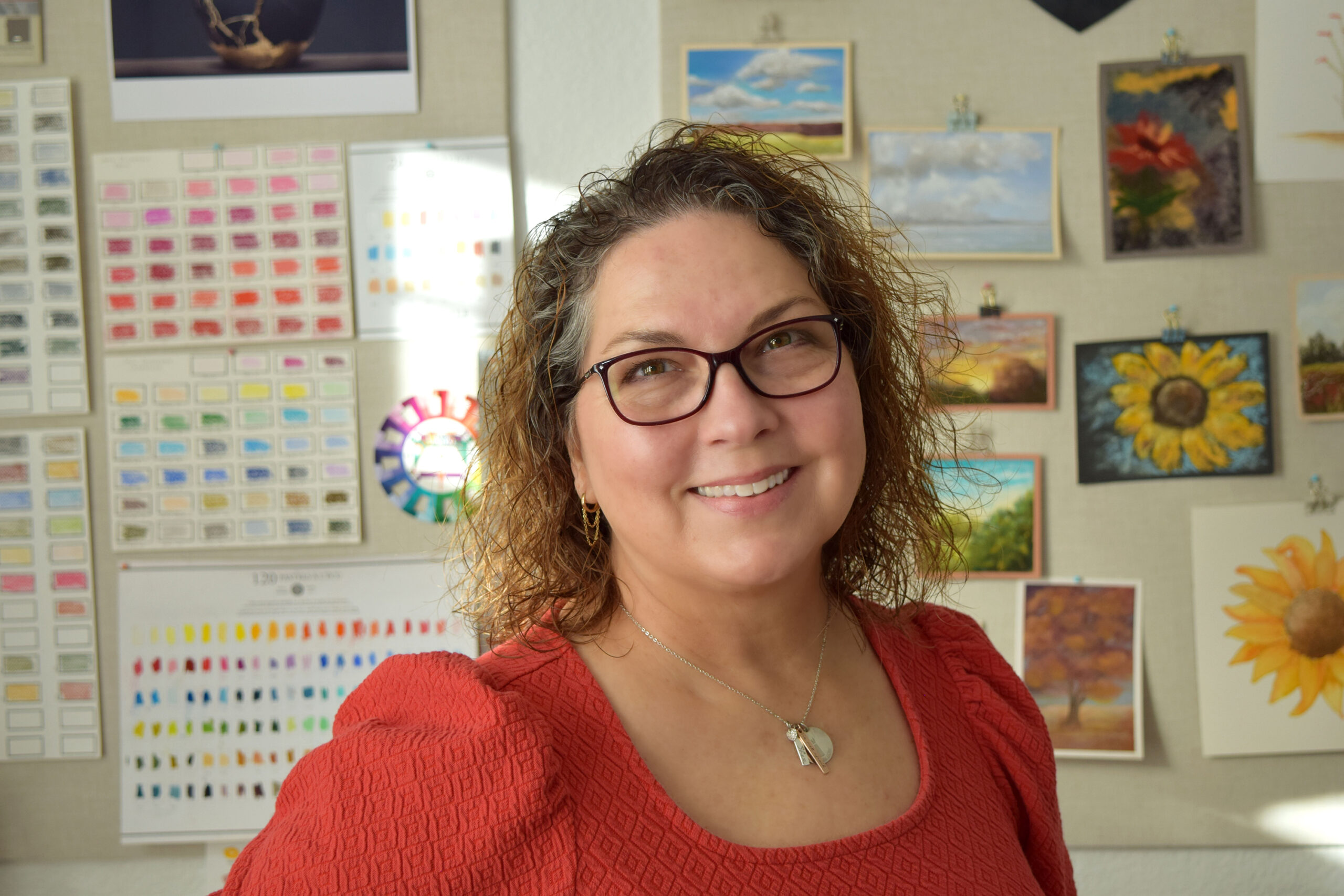 Cori smiling in her art studio